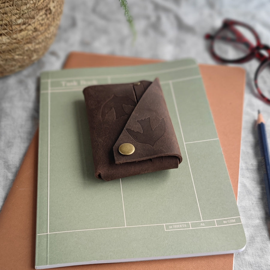 side of brown leather bird print wallet