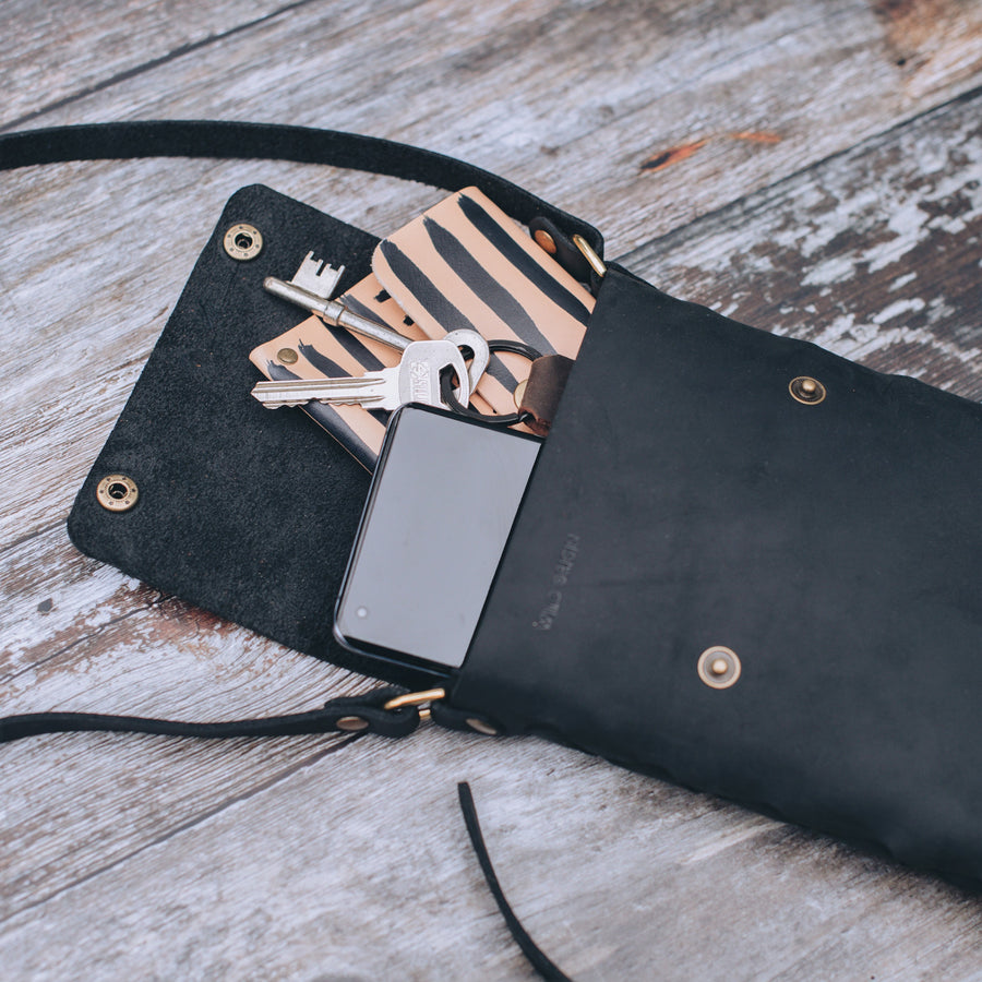 open view of black leather crossbody bag 
