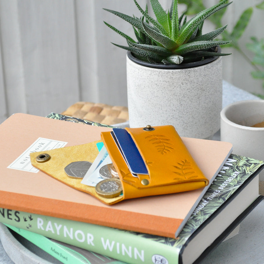 mustard botanical leather wallet in use 