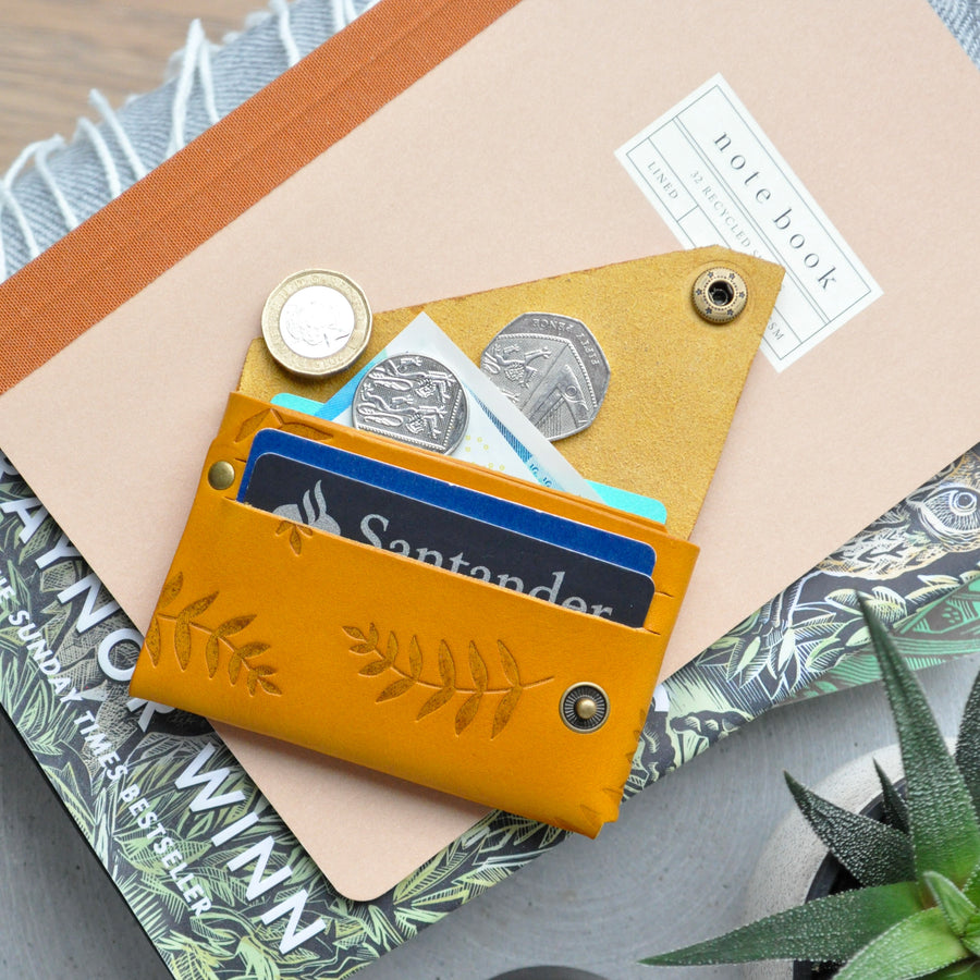 mustard botanical leather wallet in use 
