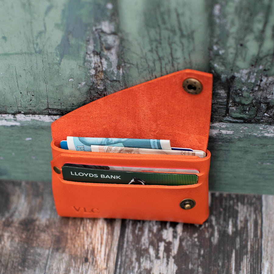 orange veg tan italian leather wallet in use 